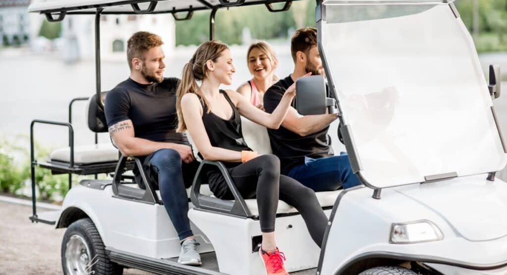 A group of friends getting around gulf shores and orange beach on a golf cart
