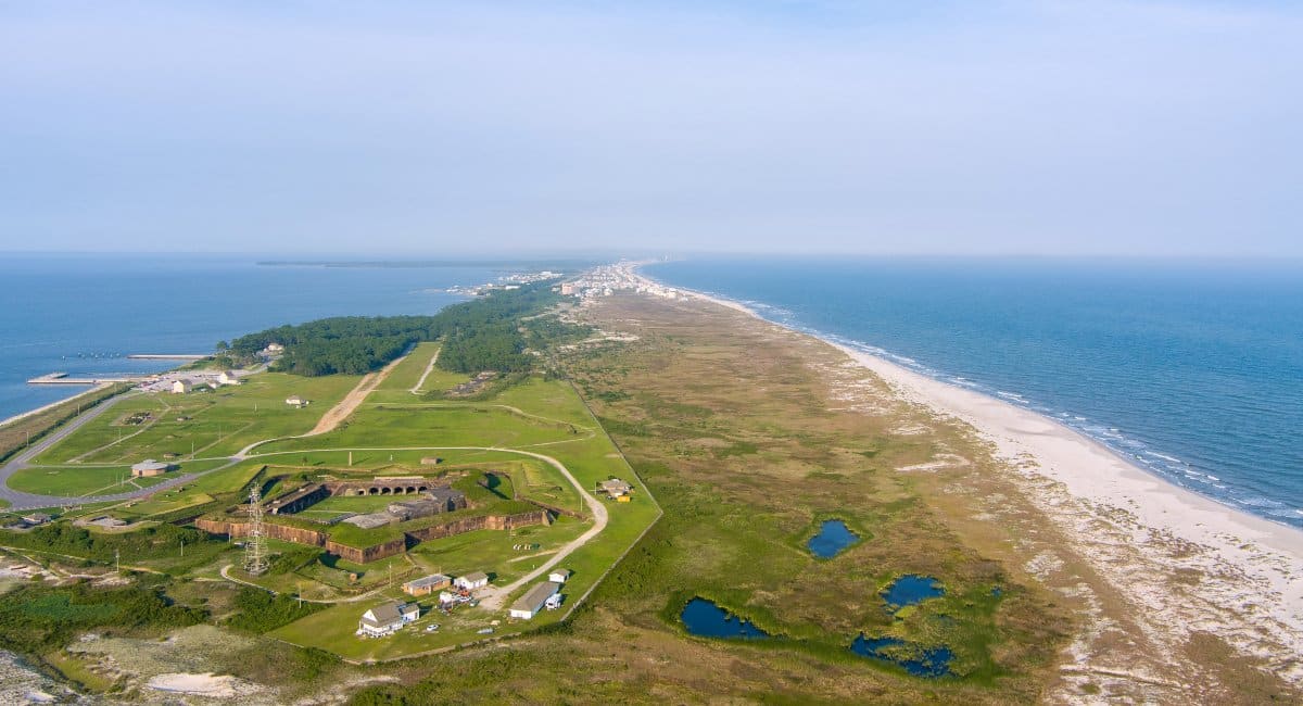 Aerial view of Fort Morgan in Gulf Shores, Alabama, with scenic coastline, showcasing historical attractions and beautiful beaches, perfect for snowbirds looking for a mix of relaxation and exploration.